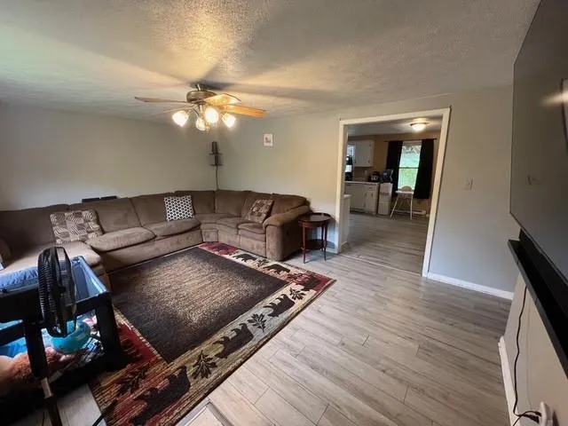 a living room with furniture and wooden floor