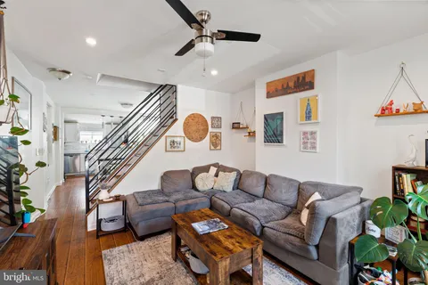 a living room with furniture and wooden floor