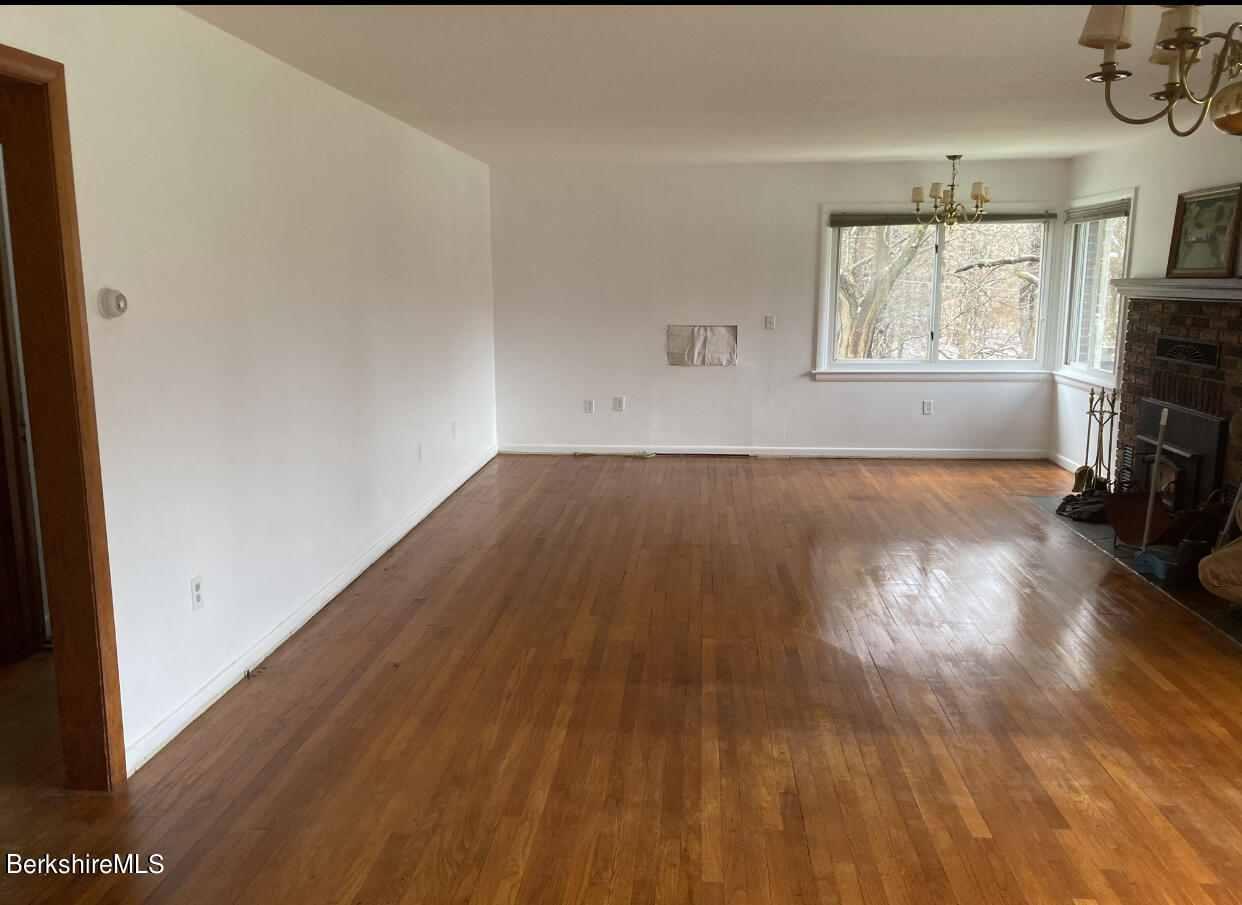 34 West Center Road West Stockbridge, MA 01266 - Photo 10 of 30 an empty room with wooden floor and windows