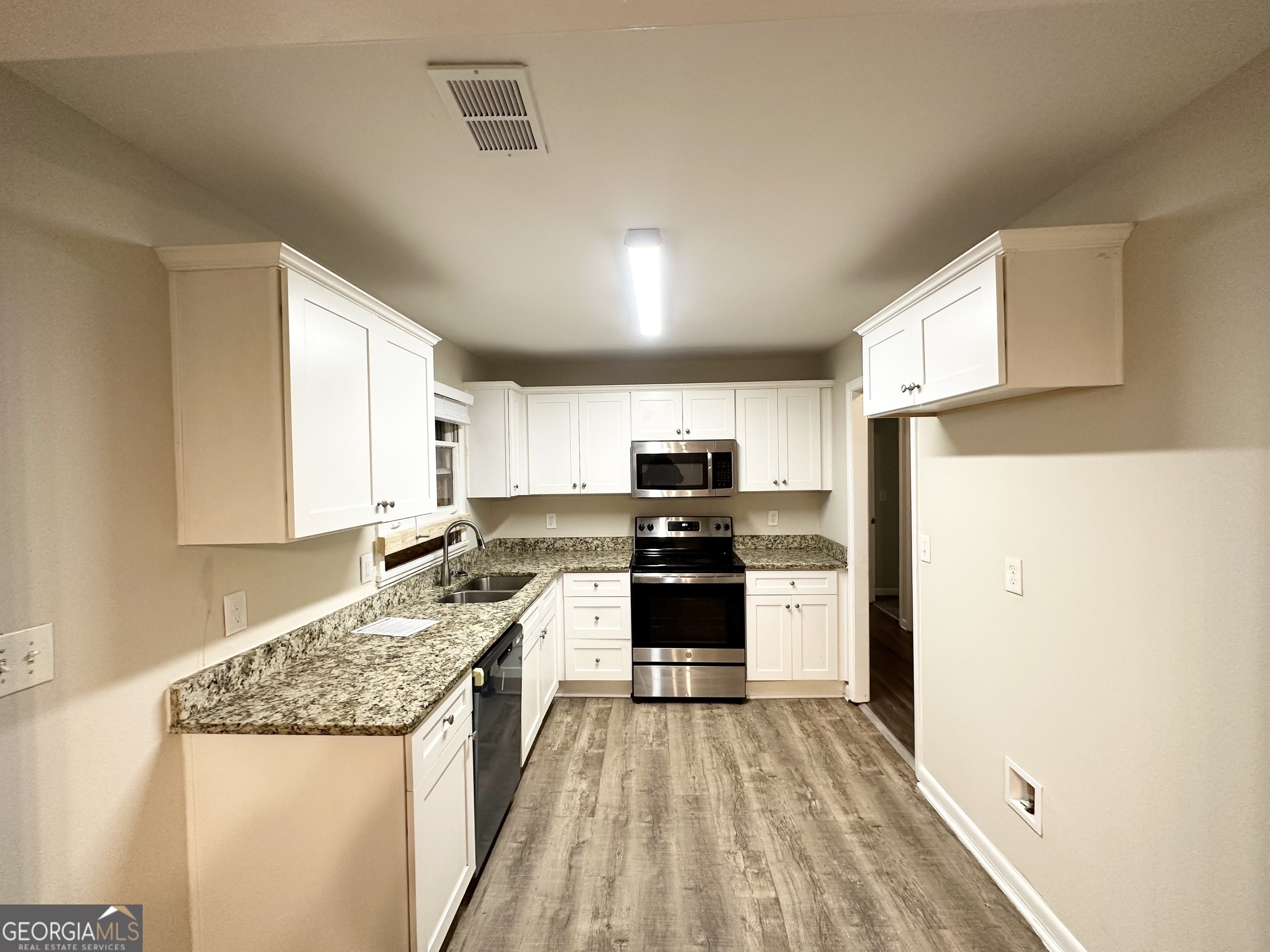4390 Mercer Road Decatur, GA 30035 - Photo 6 of 11 a kitchen with stainless steel appliances granite countertop a refrigerator and a stove top oven
