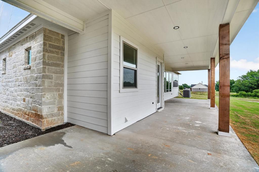 225 Kilkenny Road Poolville, TX 76487 - Photo 32 of 36 Expansive covered concrete patio featuring recessed lighting and robust wood pillars