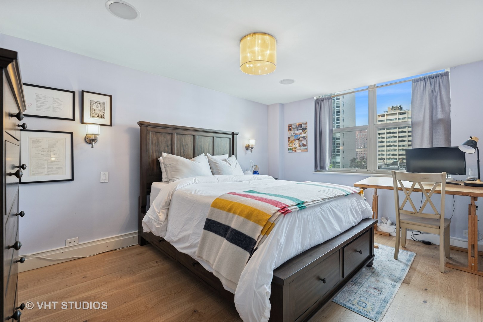 40 East Cedar Street, Unit 8CD Chicago, IL 60611 - Photo 12 of 21 a bedroom with a bed and a chandelier