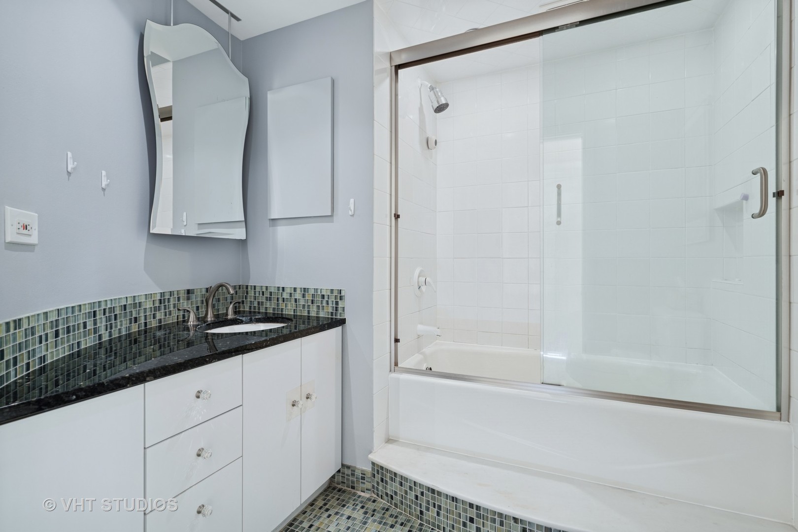40 East Cedar Street, Unit 8CD Chicago, IL 60611 - Photo 18 of 21 a bathroom with a granite countertop sink mirror and bathtub