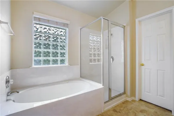 a bathroom with bathtub and a shower