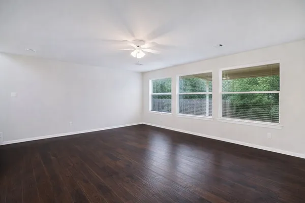 a view of wooden floor and windows in a room