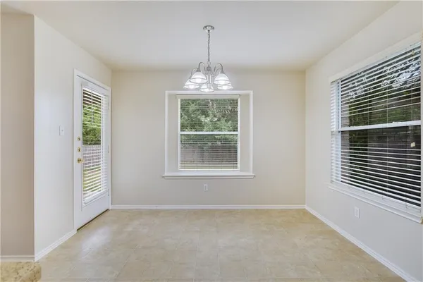 an empty room with windows and entrance