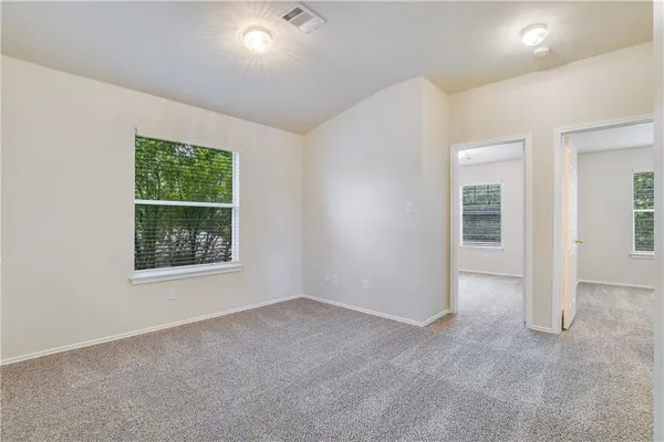 an empty room with windows and closet