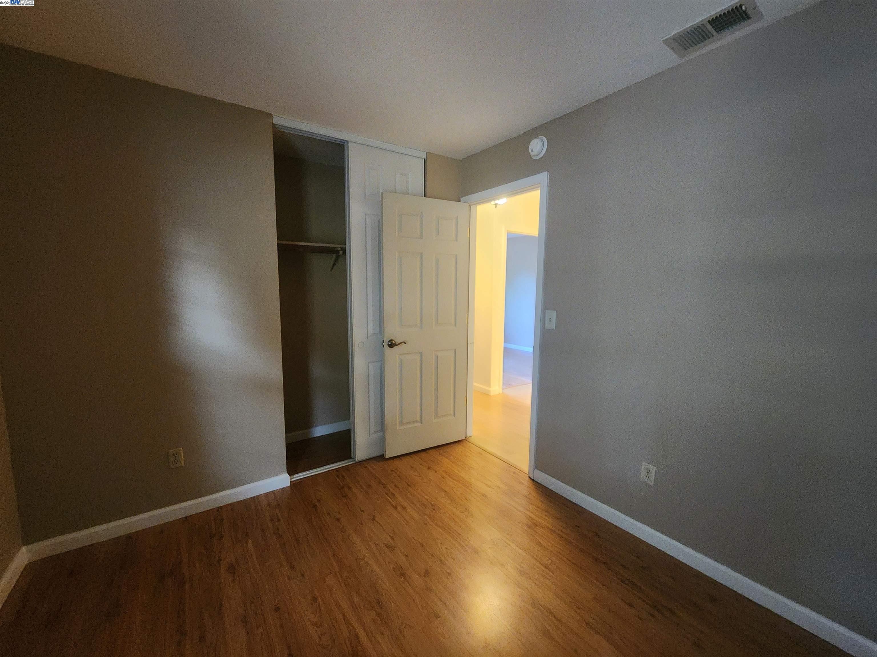 1733 Carnation Circle Livermore, CA 94551 - Photo 11 of 27 an empty room with wooden floor and closet