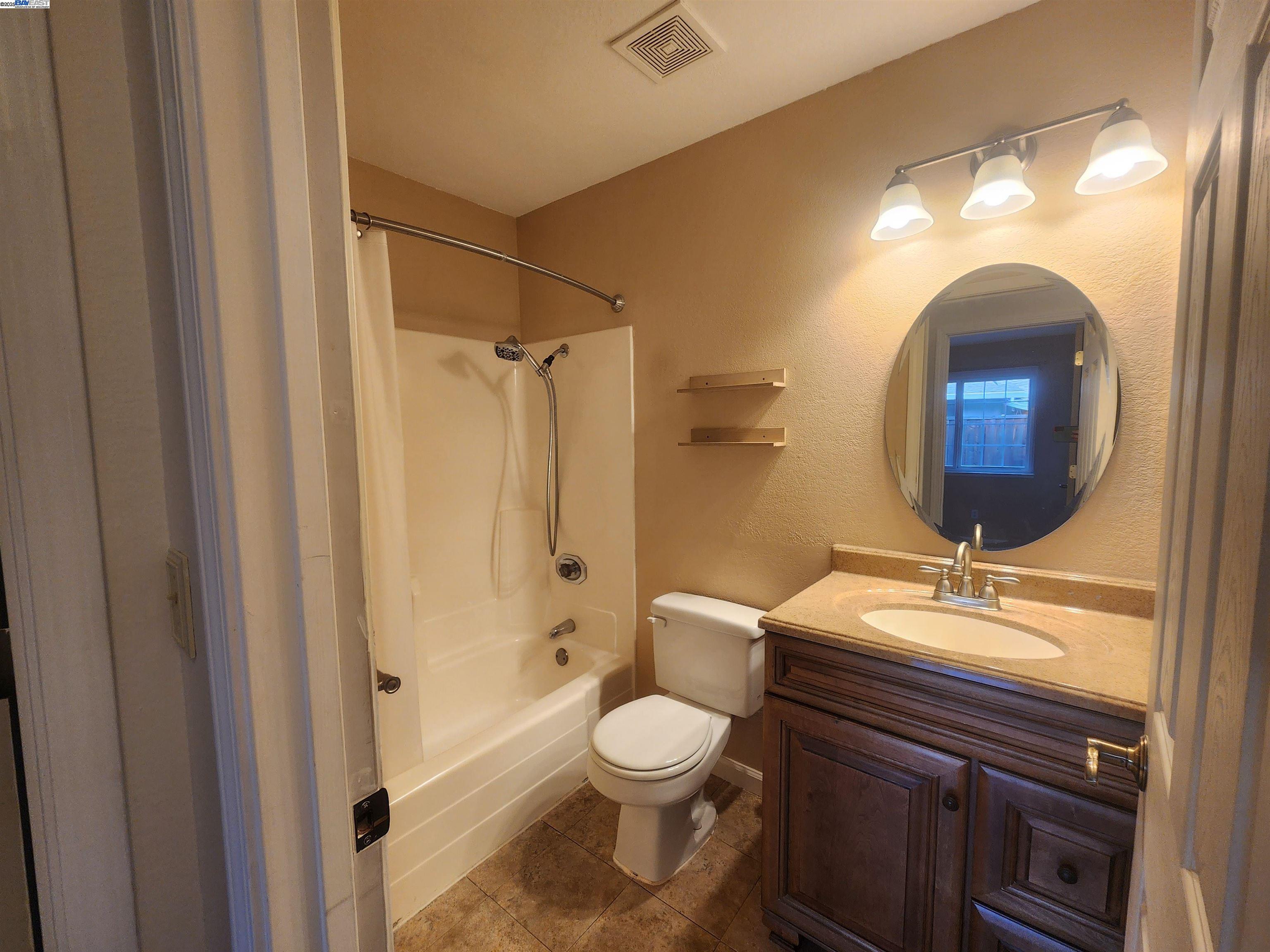 1733 Carnation Circle Livermore, CA 94551 - Photo 15 of 27 a bathroom with a toilet sink vanity granite and shower