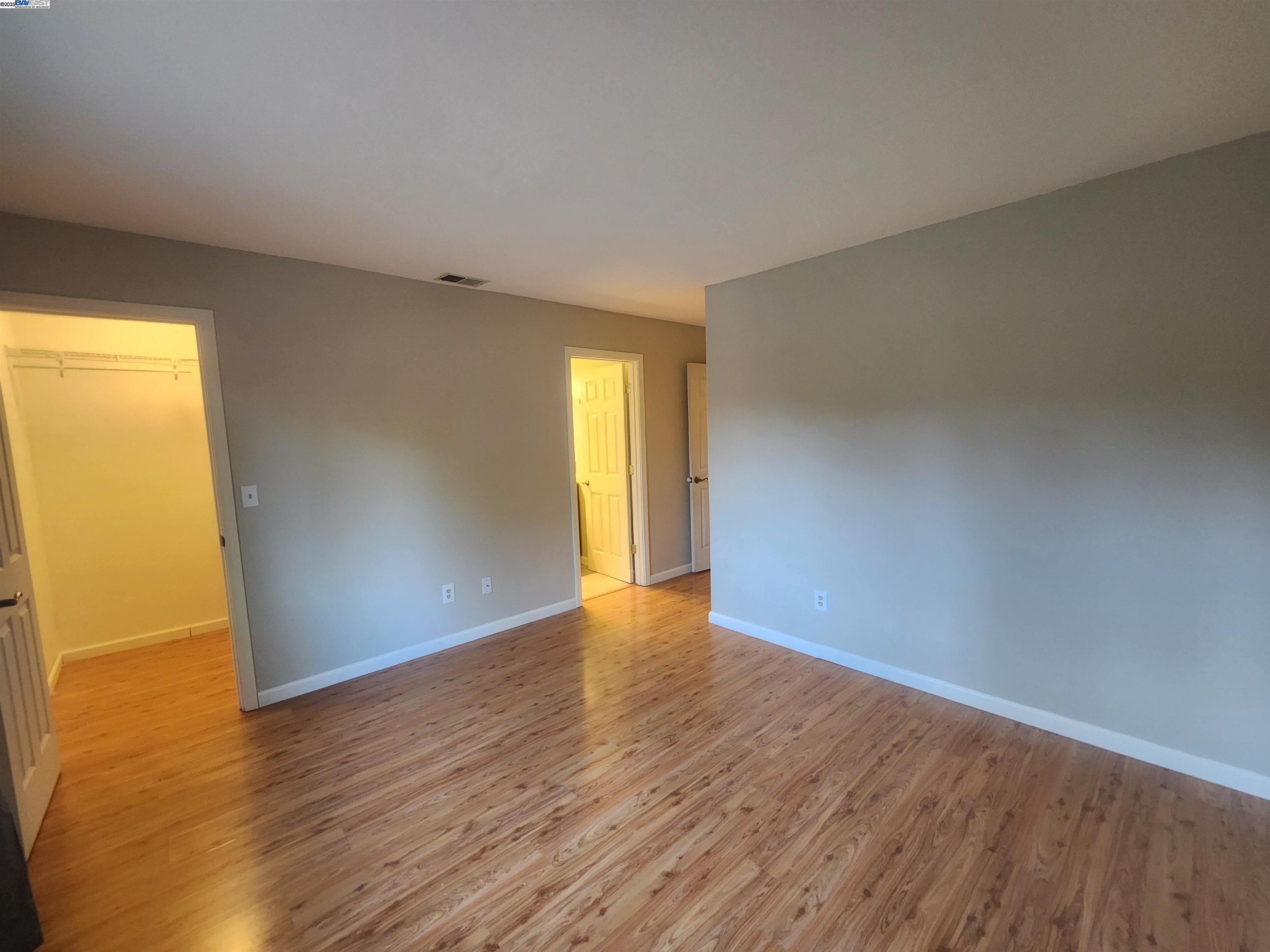 1733 Carnation Circle Livermore, CA 94551 - Photo 21 of 27 a view of an empty room with wooden floor and a window
