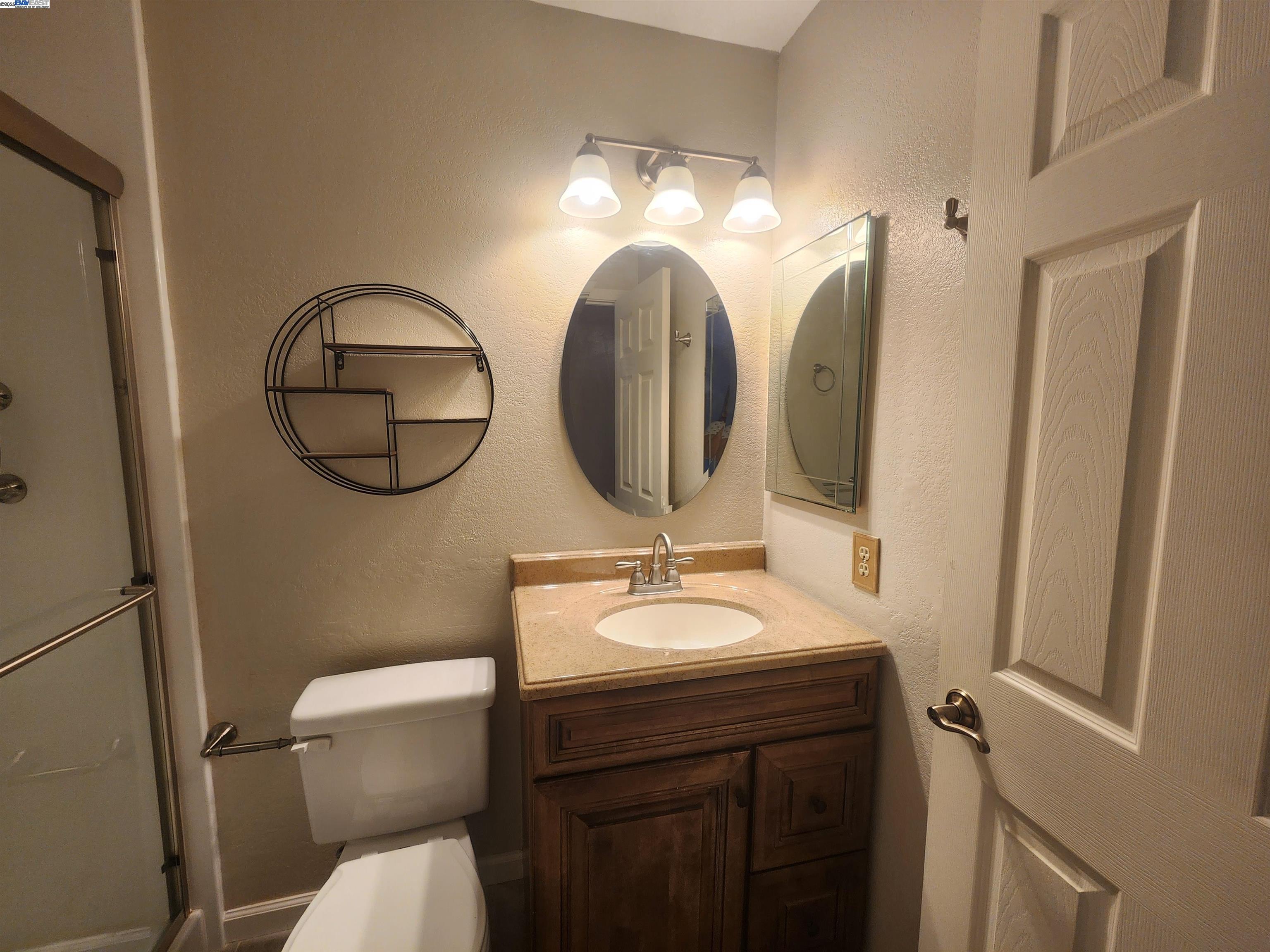 1733 Carnation Circle Livermore, CA 94551 - Photo 22 of 27 a bathroom with a toilet a sink and a mirror