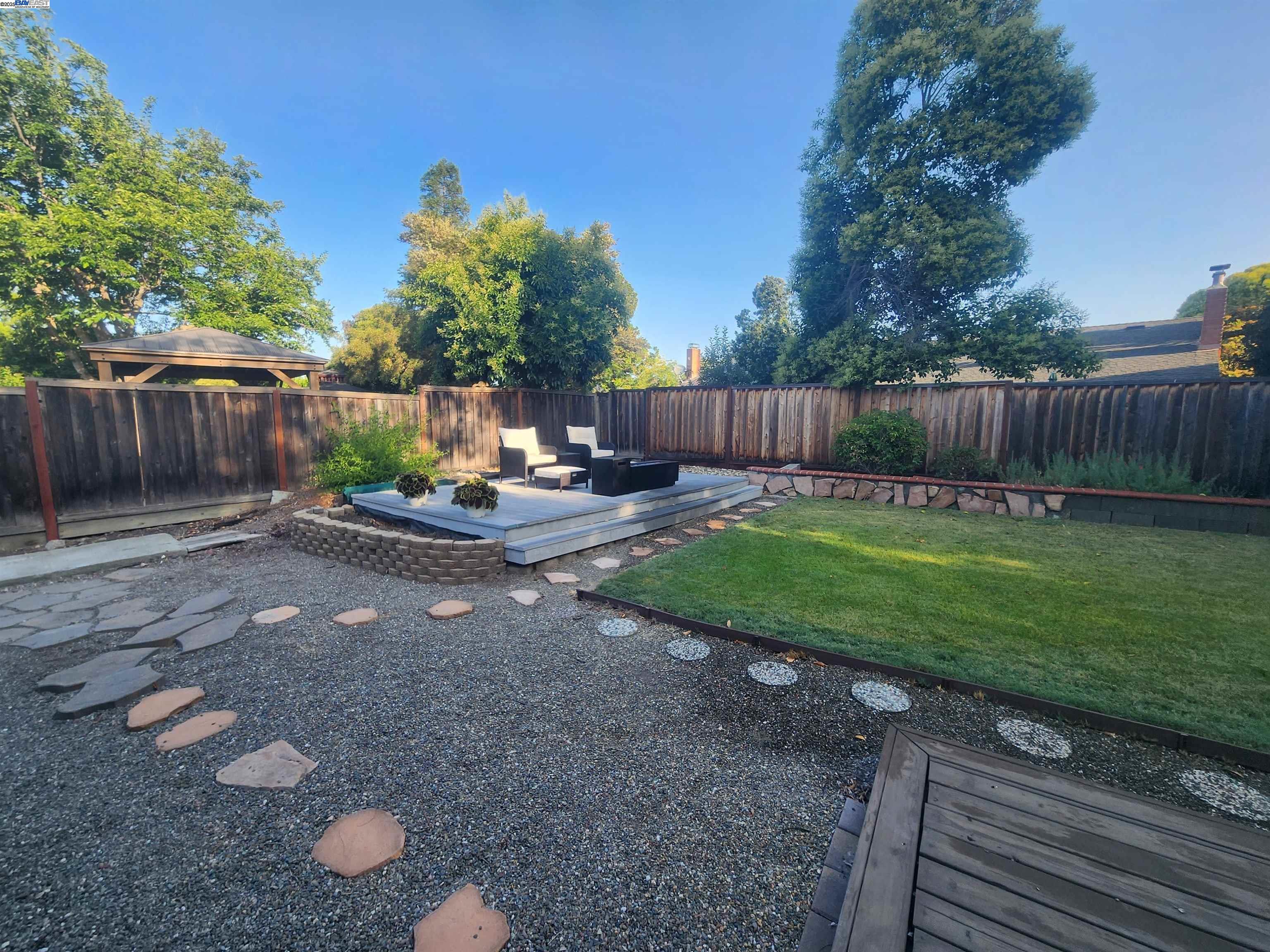 1733 Carnation Circle Livermore, CA 94551 - Photo 24 of 27 a view of a backyard with plants and wooden fence
