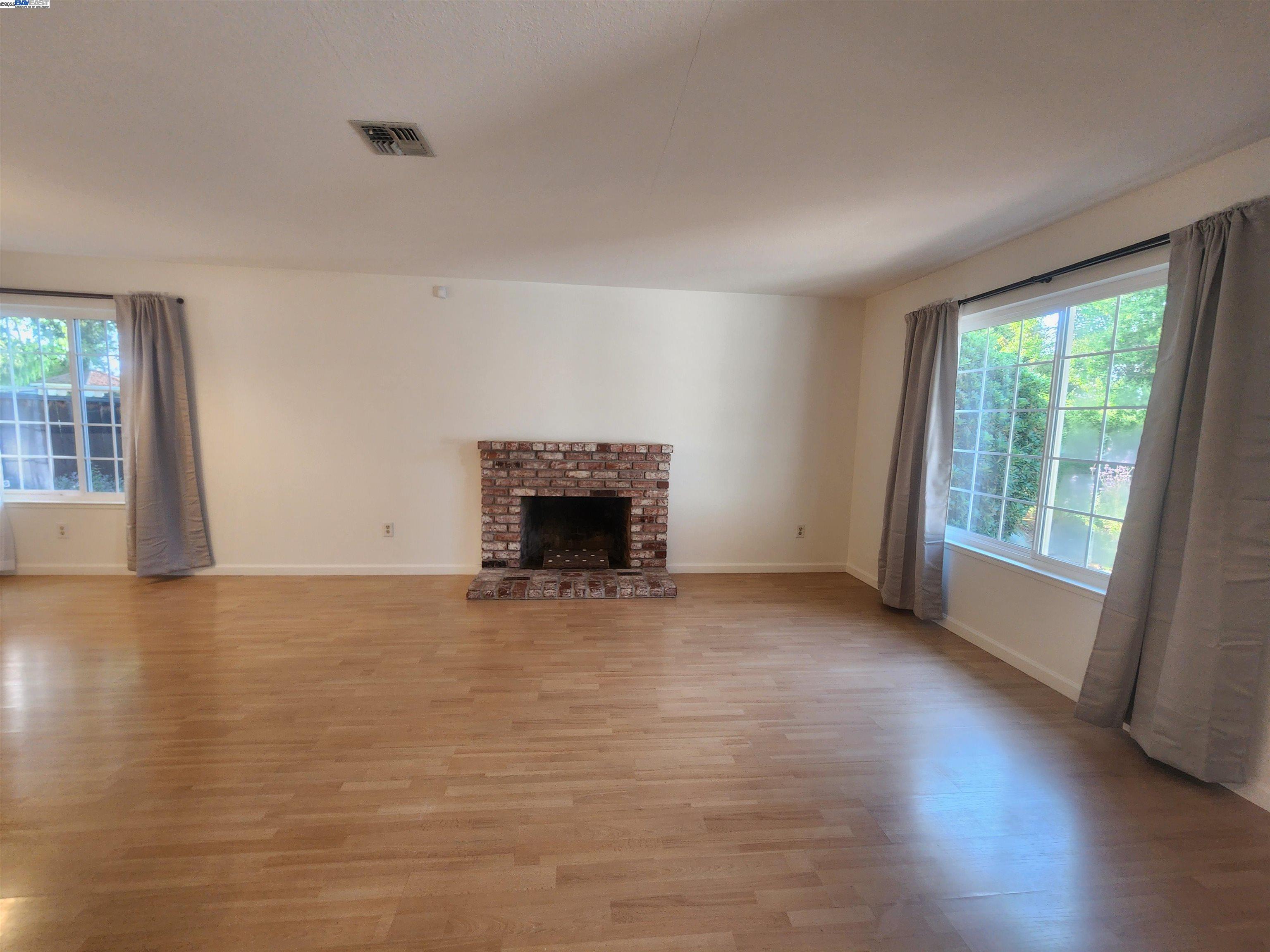 1733 Carnation Circle Livermore, CA 94551 - Photo 4 of 27 a view of empty room with wooden floor and fireplace