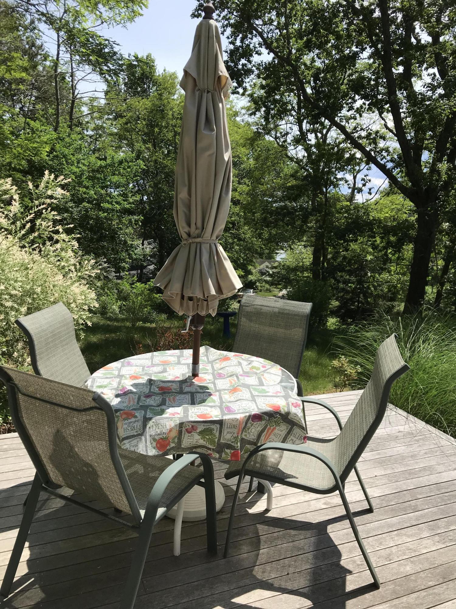 41 Castle Road Truro, MA 02666 - Photo 16 of 16 a table and chairs in a patio