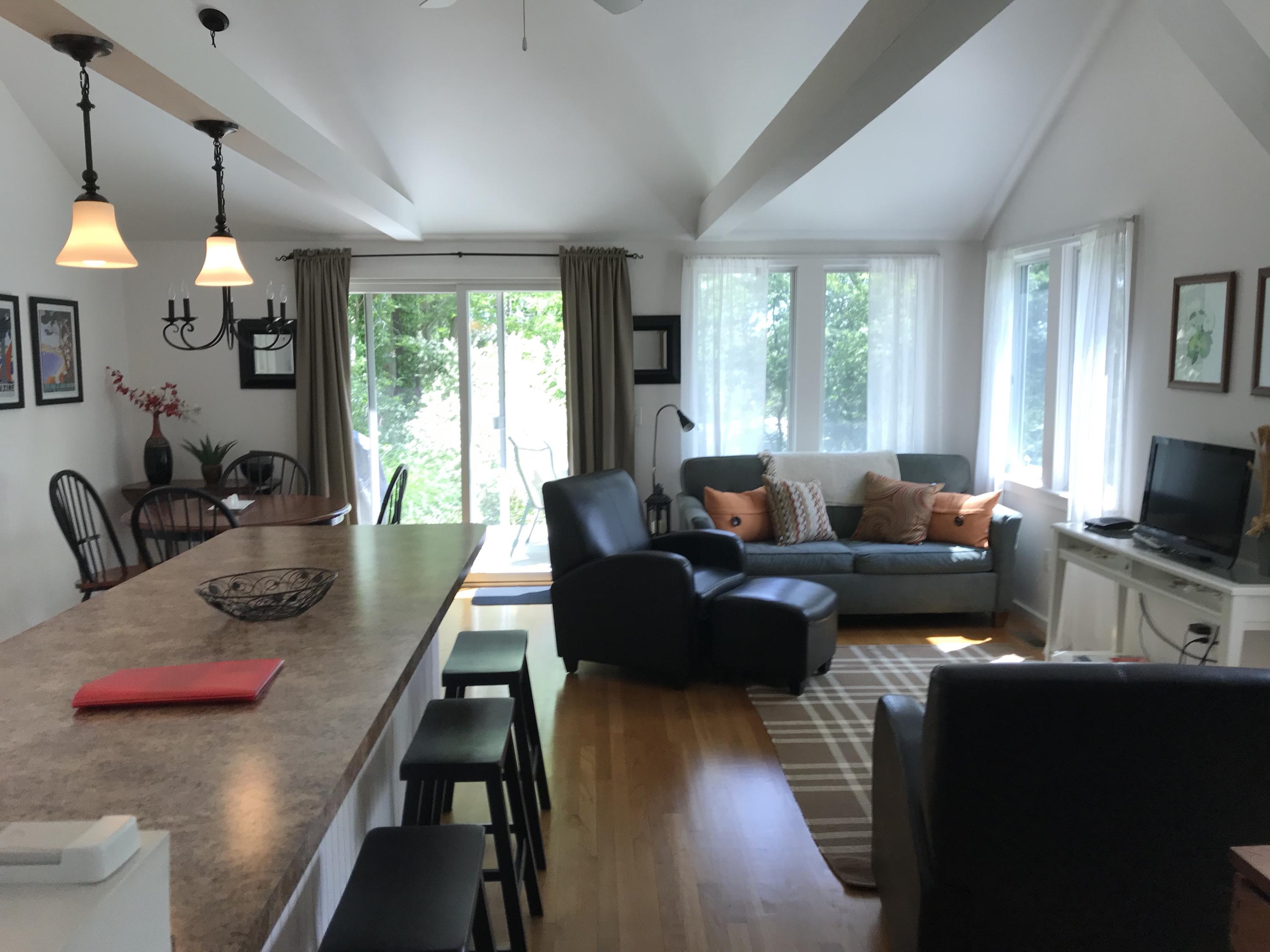 41 Castle Road Truro, MA 02666 - Photo 7 of 16 a living room with furniture flat screen tv and a large window