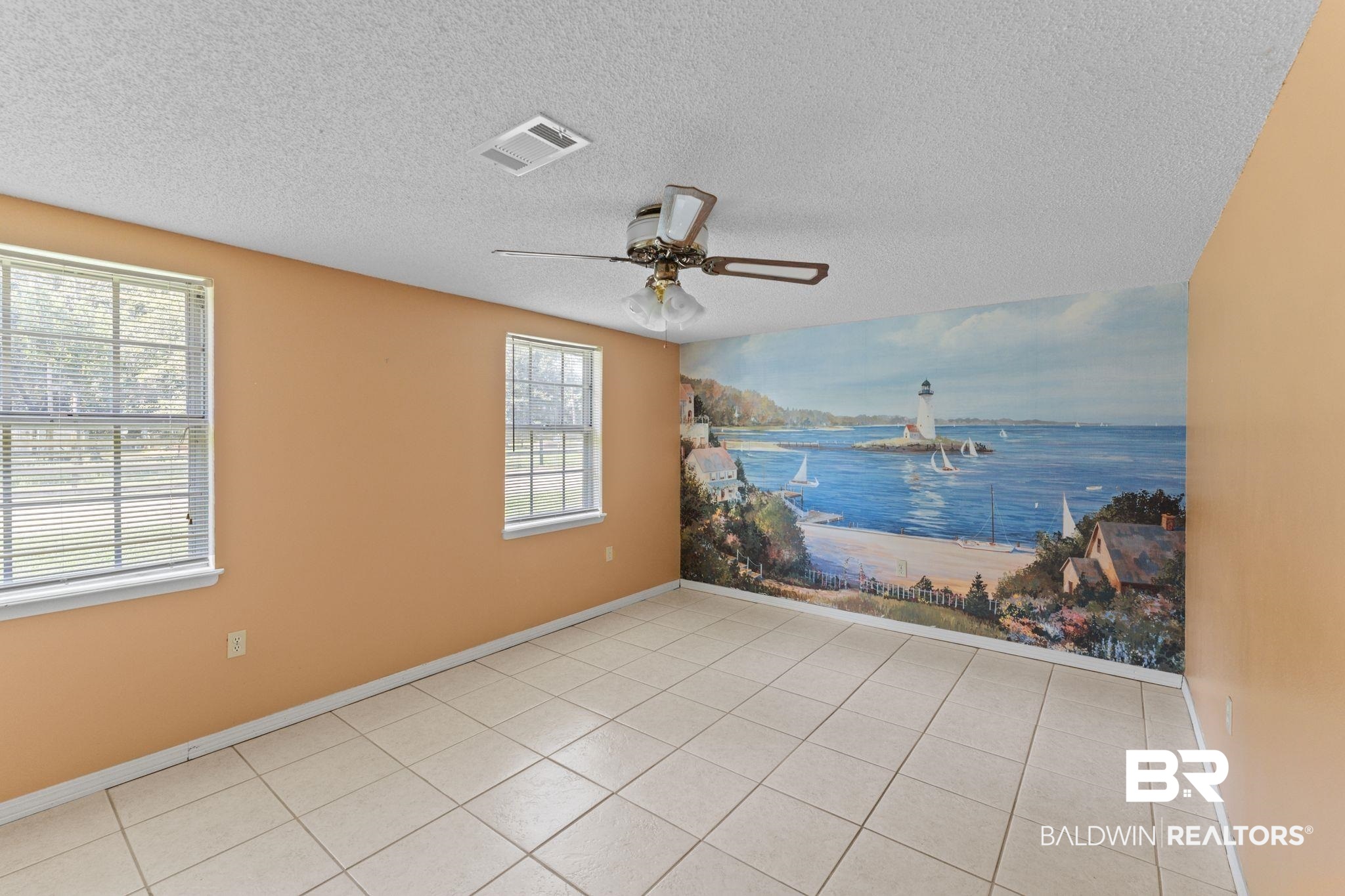 14095 Riverside Drive Foley, AL 36535 - Photo 14 of 30 Empty room featuring a textured ceiling, ceiling fan, tile patterned flooring, and a water view