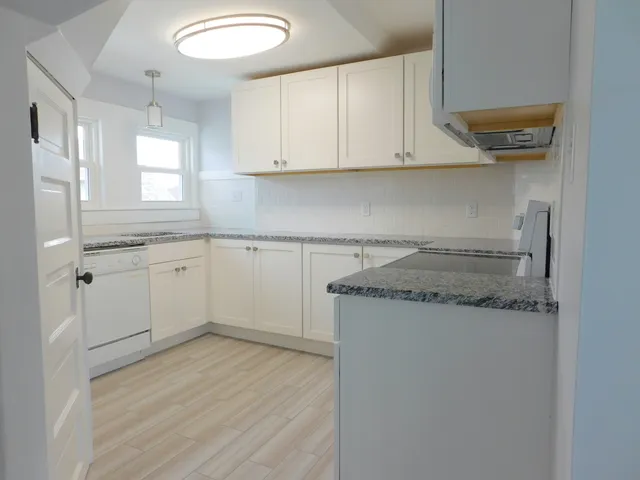 a view of a kitchen with sink and cabinets