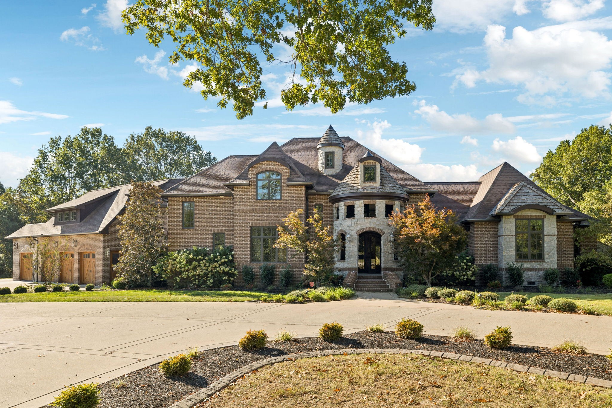 a front view of a house with a yard and garage