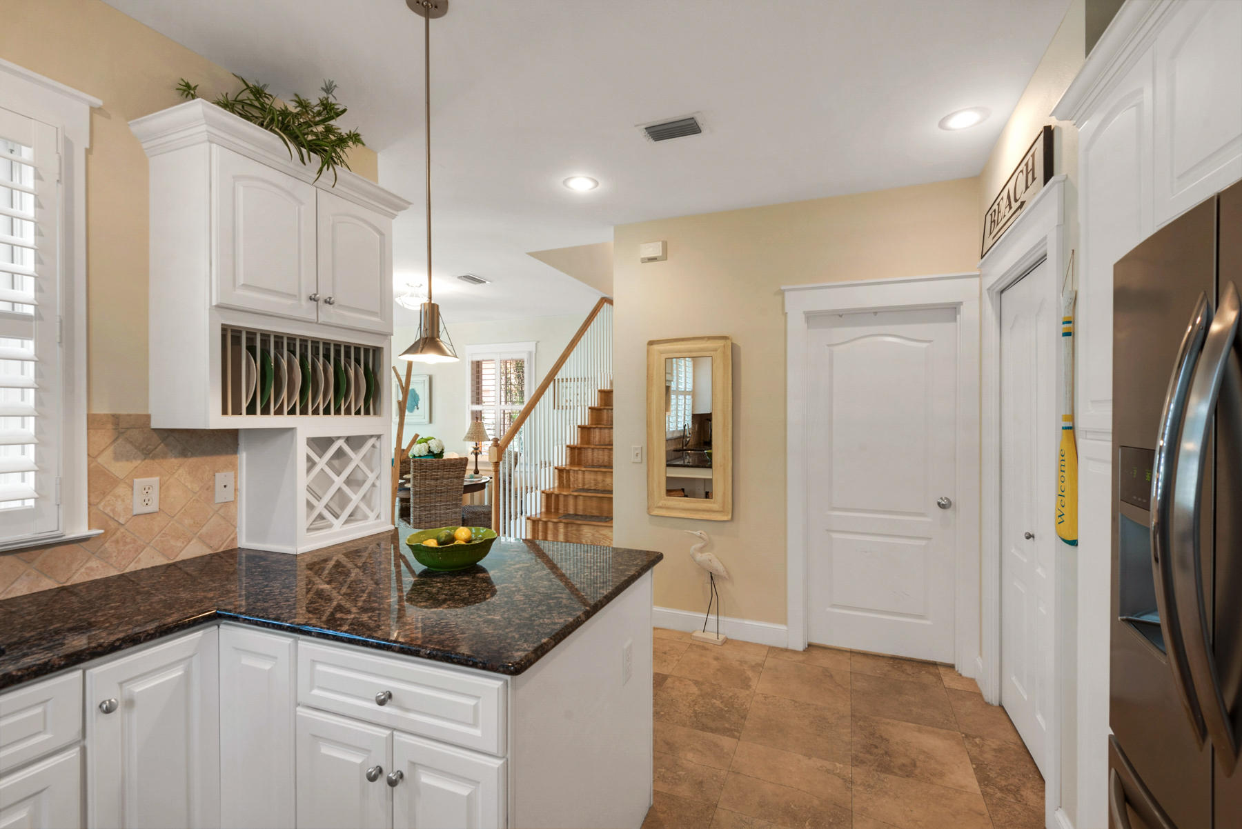 31 Sunset Beach Blvd Inlet Beach Inlet Beach, FL 32461 - Photo 12 of 28 a kitchen with stainless steel appliances granite countertop a refrigerator a oven and white cabinets with wooden floor