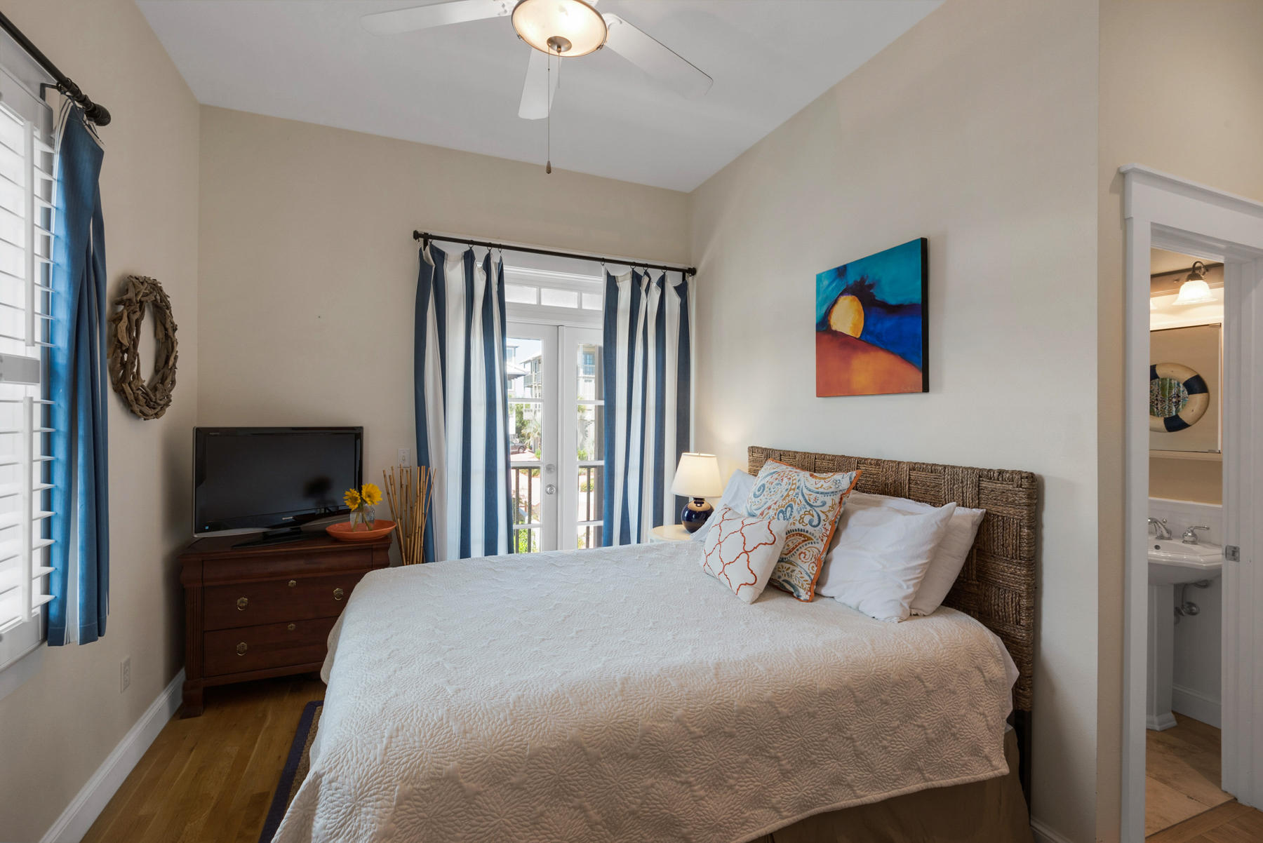 31 Sunset Beach Blvd Inlet Beach Inlet Beach, FL 32461 - Photo 15 of 28 a bedroom with a bed and a flat tv screen on a dresser