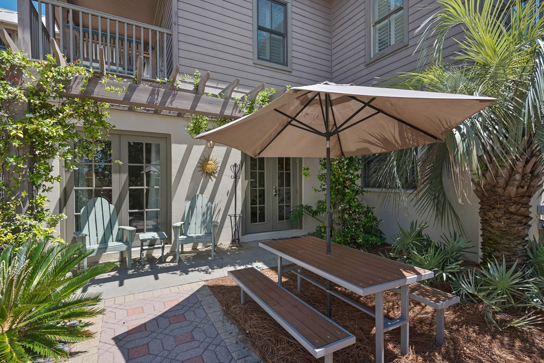 31 Sunset Beach Blvd Inlet Beach Inlet Beach, FL 32461 - Photo 4 of 28 a view of a patio with a table and chairs under an umbrella