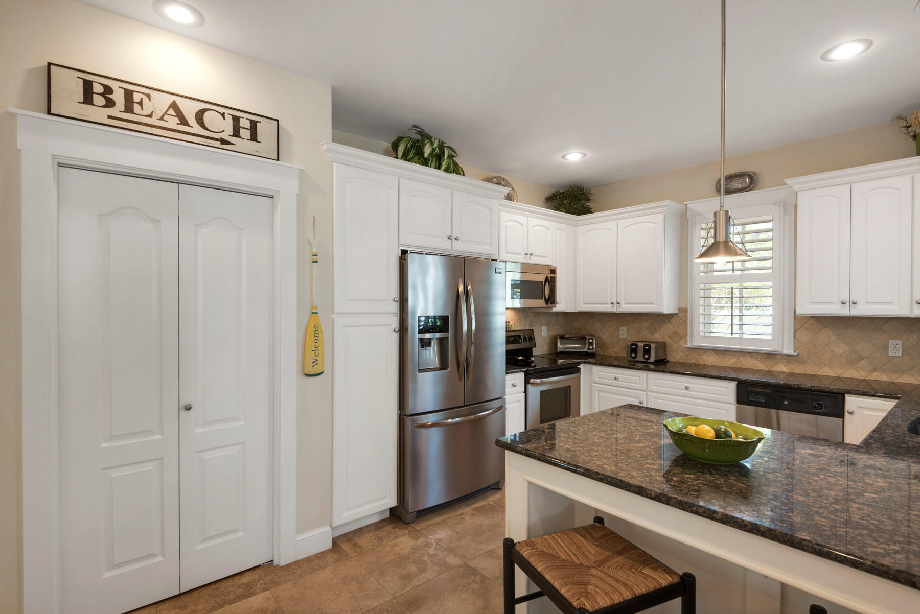 31 Sunset Beach Blvd Inlet Beach Inlet Beach, FL 32461 - Photo 10 of 28 a kitchen with granite countertop stainless steel appliances a refrigerator a sink a stove cabinets and chairs