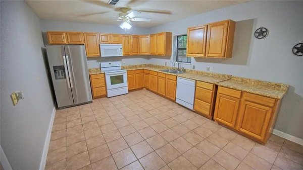 a kitchen with stainless steel appliances a refrigerator and a sink