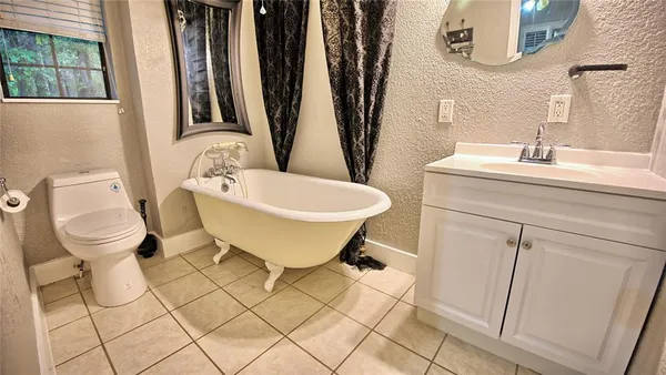 a spacious bathroom with a sink and a toilet