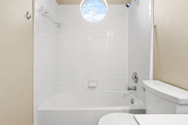a bathroom with a bathtub and a toilet