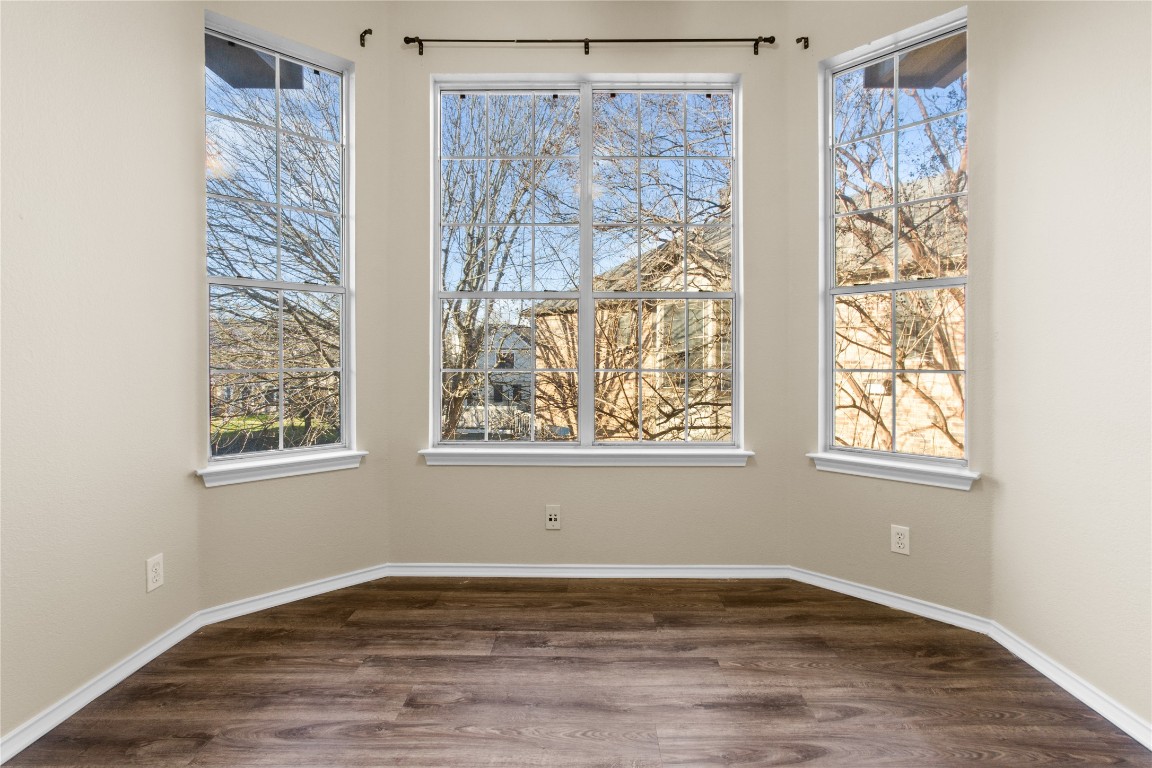 12401 Los Indios Trail, Unit 44 Austin, TX 78729 - Photo 20 of 28 a view of an empty room with wooden floor and a window