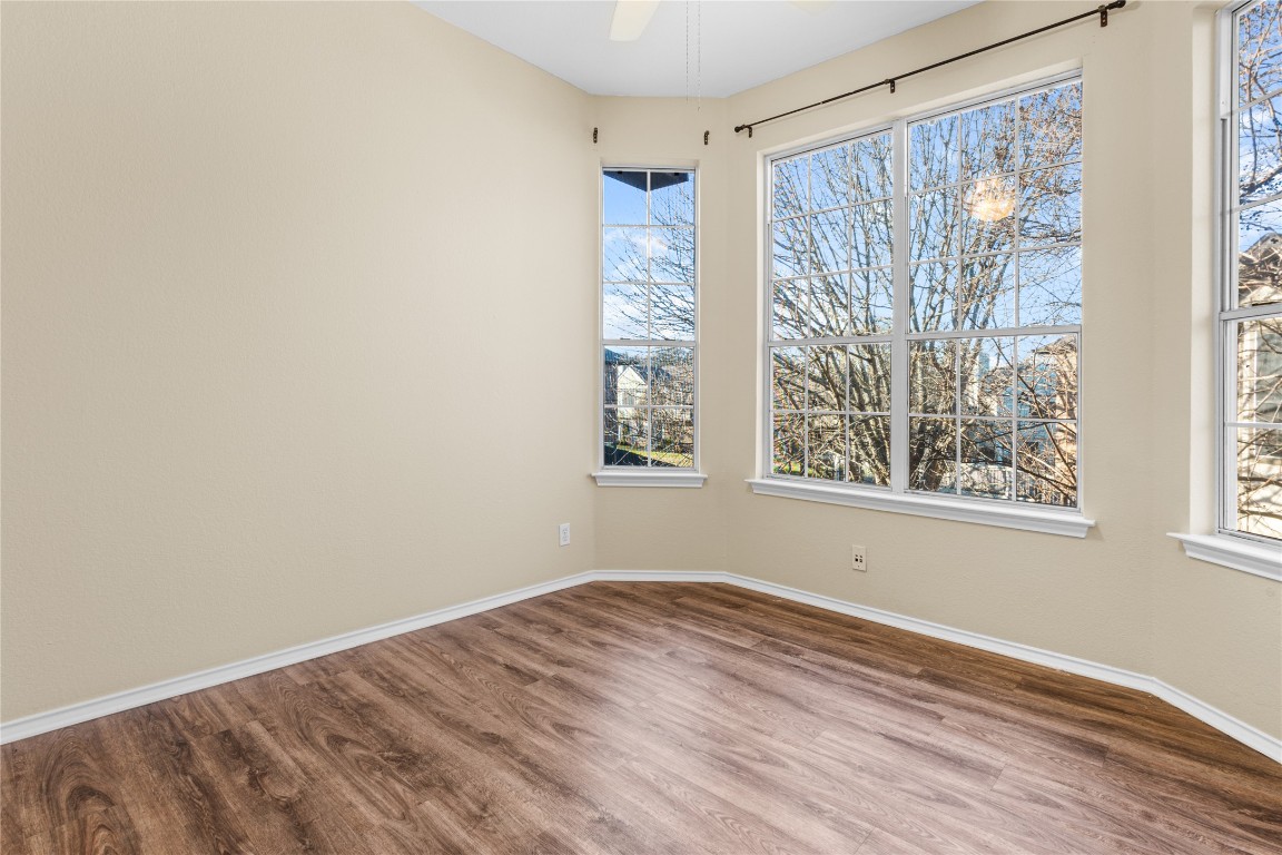 12401 Los Indios Trail, Unit 44 Austin, TX 78729 - Photo 24 of 28 a view of room with window and hardwood floor