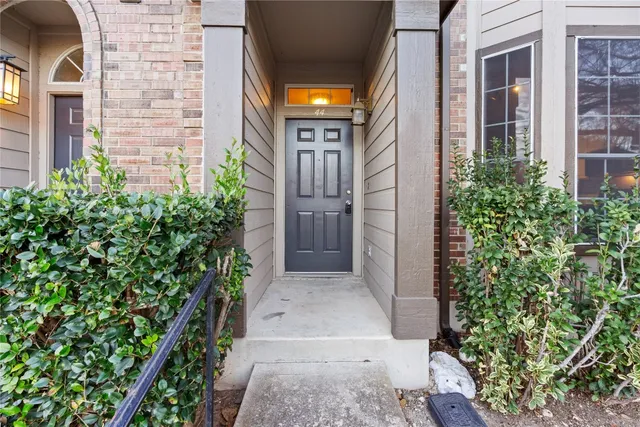 view of a brick house with plants
