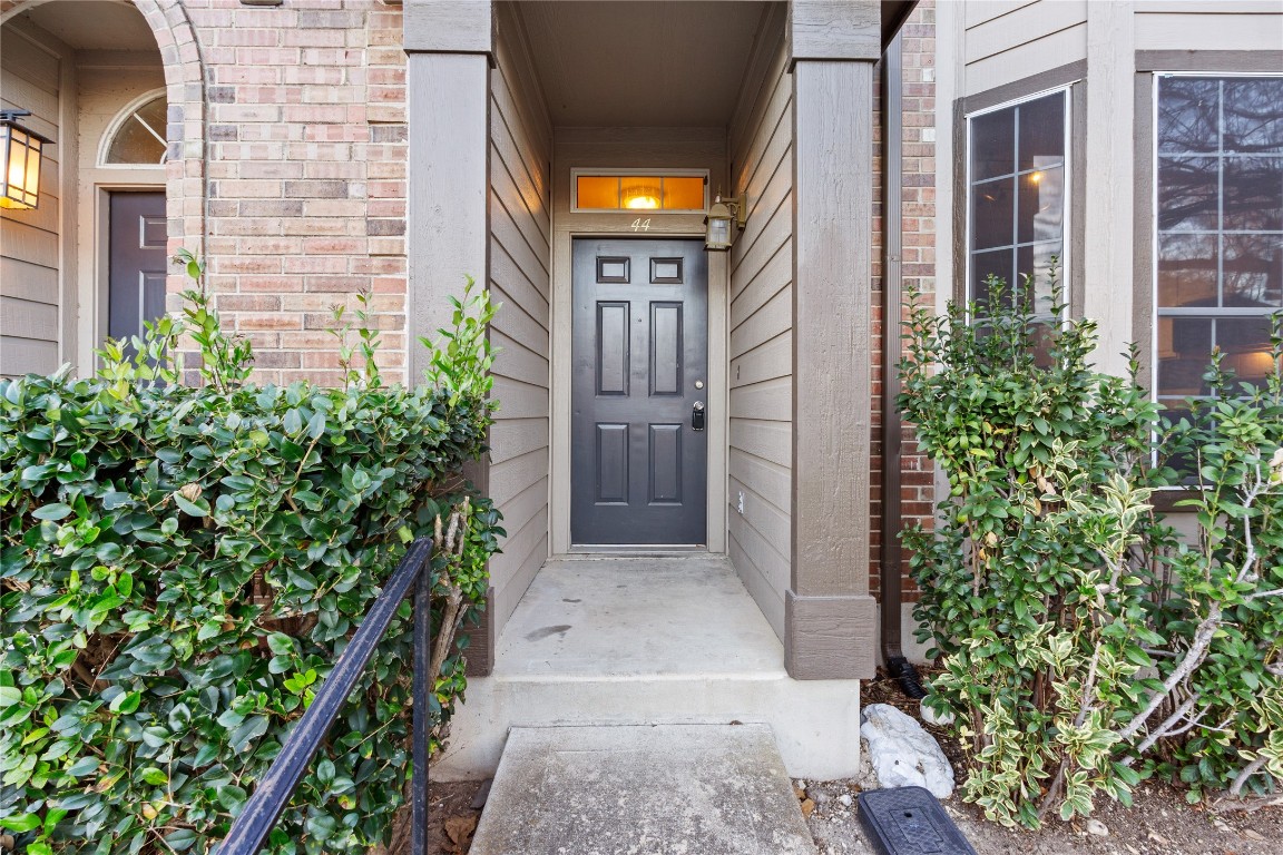 12401 Los Indios Trail, Unit 44 Austin, TX 78729 - Photo 25 of 28 view of a brick house with plants