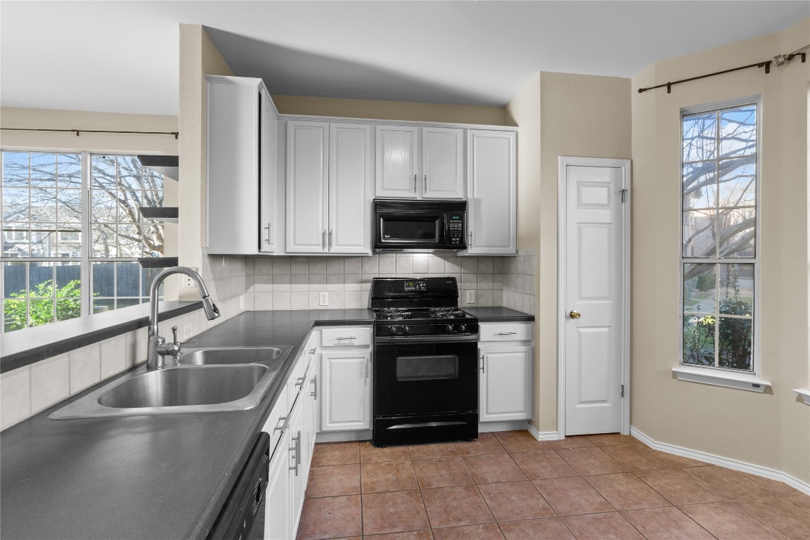 12401 Los Indios Trail, Unit 44 Austin, TX 78729 - Photo 6 of 28 a kitchen with a stove a sink and a refrigerator