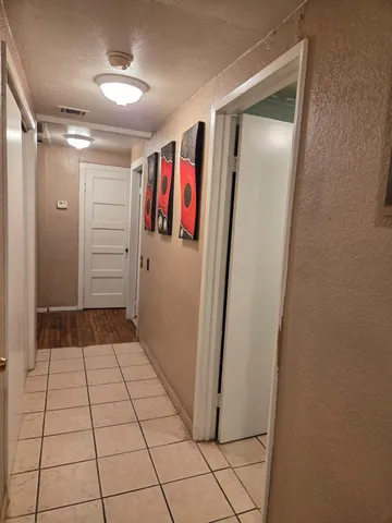 a view of walk in closet with clothes and dryer