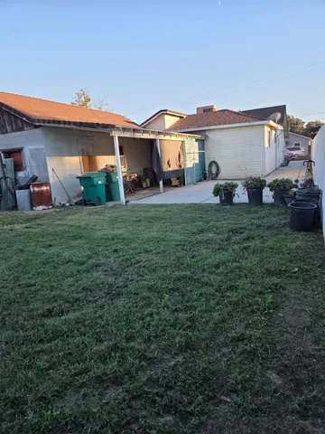 a front view of a house with a garden and trees