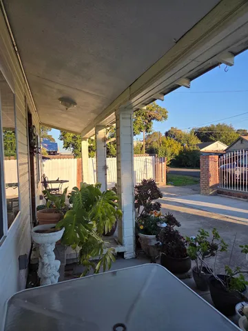 a view of a porch with a potted plant