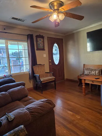 a living room with furniture a window and a clock