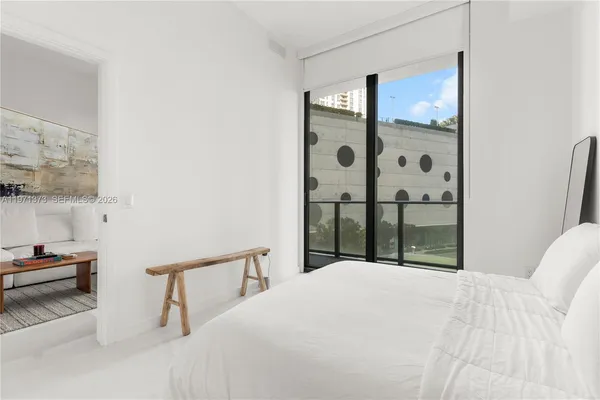 a bedroom with a bed and a mirror