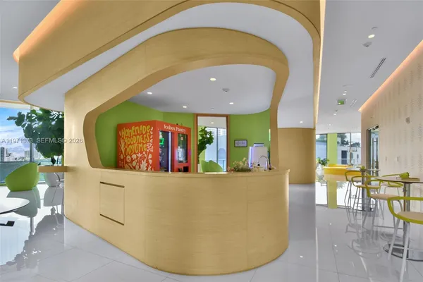 a living room filled with furniture and a potted plant