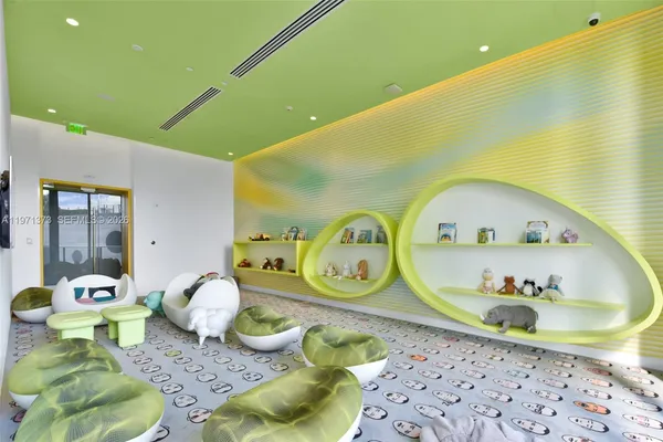 a swimming pool with a pool table and chairs