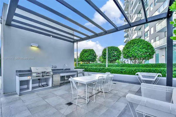 a view of a backyard with plants and outdoor seating