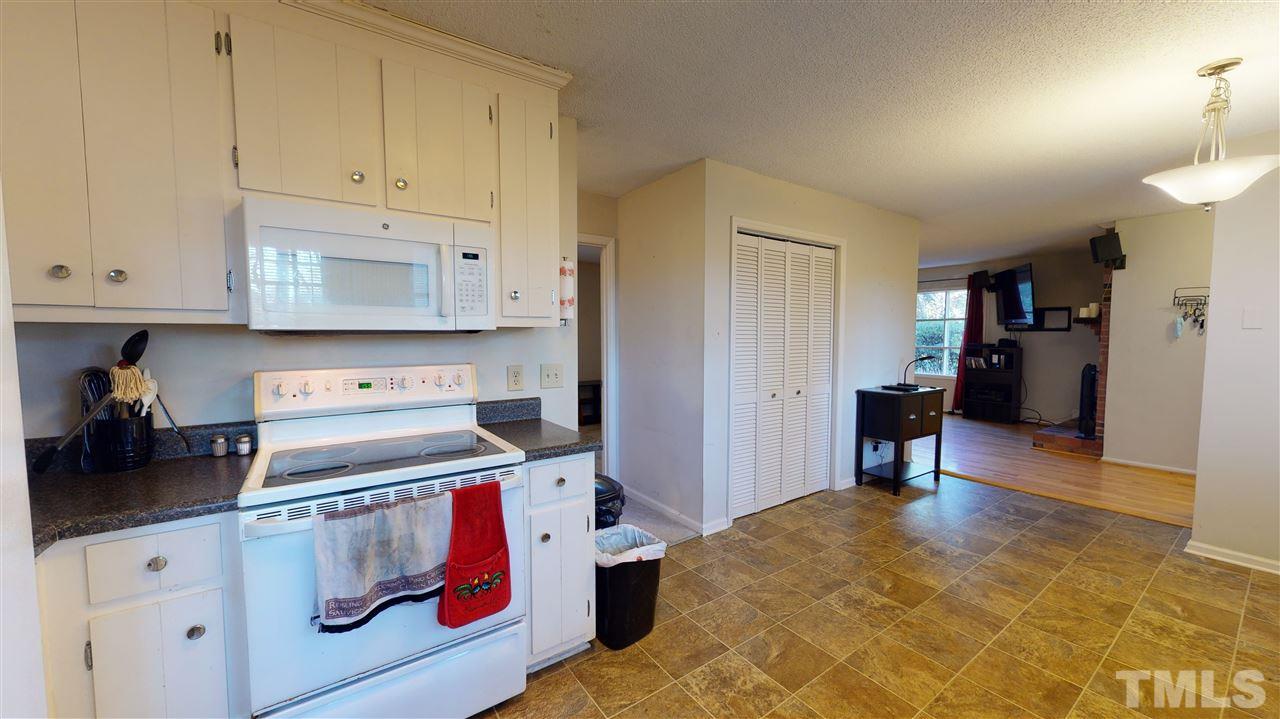 1503 Cole Mill Road Durham, NC 27705 - Photo 11 of 29 a kitchen with stainless steel appliances granite countertop a stove a sink and a refrigerator