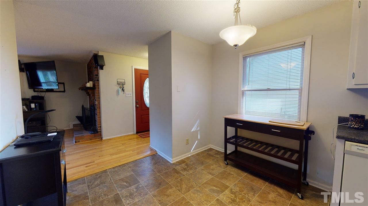1503 Cole Mill Road Durham, NC 27705 - Photo 12 of 29 a view of an empty room with kitchen and a window
