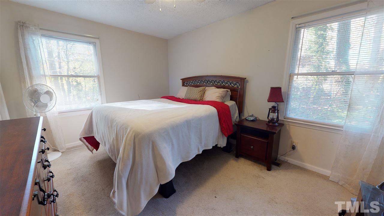 1503 Cole Mill Road Durham, NC 27705 - Photo 17 of 29 a bedroom with a bed and a window