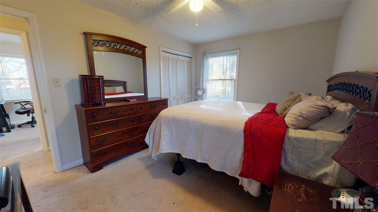 1503 Cole Mill Road Durham, NC 27705 - Photo 18 of 29 a bedroom with a bed and a dresser