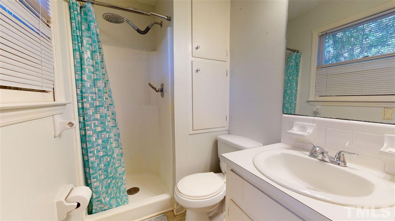 1503 Cole Mill Road Durham, NC 27705 - Photo 19 of 29 a bathroom with a sink toilet and shower