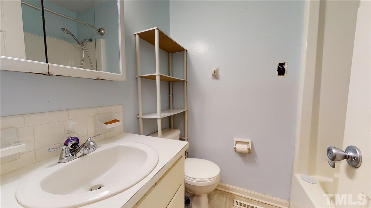 1503 Cole Mill Road Durham, NC 27705 - Photo 20 of 29 a bathroom with a sink and a toilet
