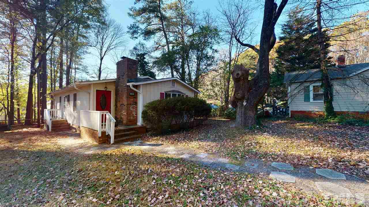 1503 Cole Mill Road Durham, NC 27705 - Photo 28 of 29 a view of a house with a yard tree and wooden fence