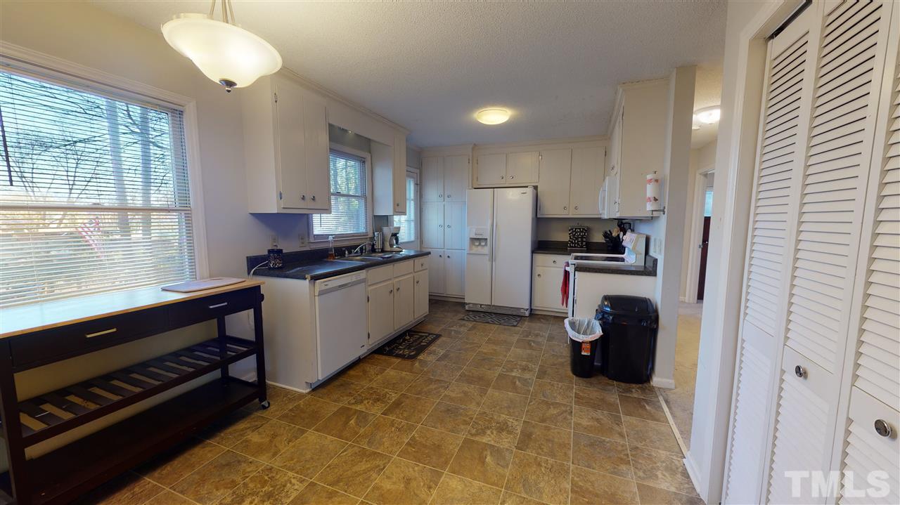 1503 Cole Mill Road Durham, NC 27705 - Photo 7 of 29 a kitchen with a stove a sink and a refrigerator